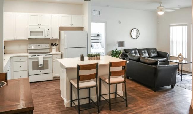 a kitchen with a dining table and couches