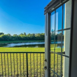 a door and a gate with a field and water