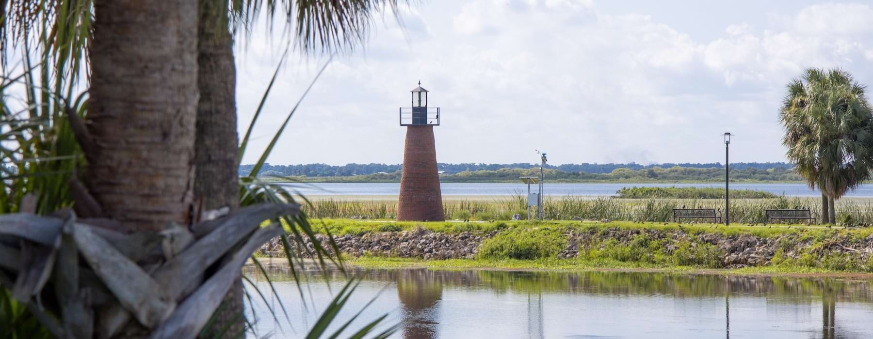 a body of water with a lighthouse in the distance